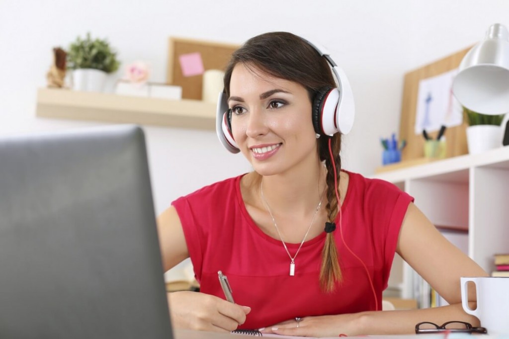 Find Virtual Assistant Needs Image in Outsource Workers - Woman in Red Happily Doing Computer Works and Headset
